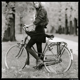French girl on a bike on a windy autumn day near Leuven